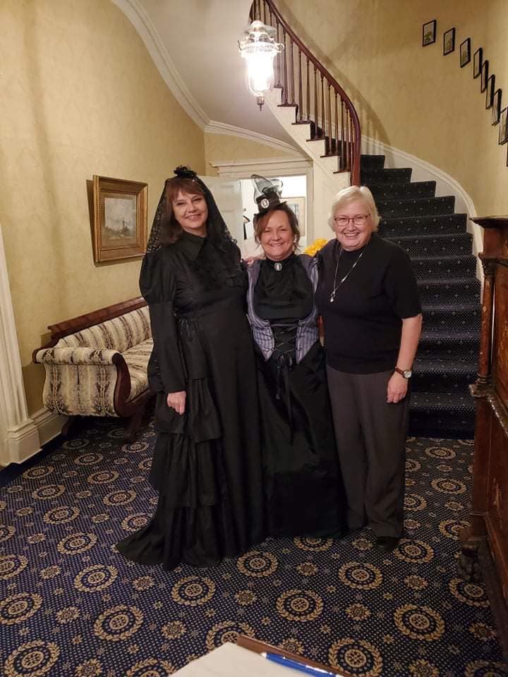 2019 Victorian Halloween Party at the Georgian - three women pose for a picture in front of spiral staircase