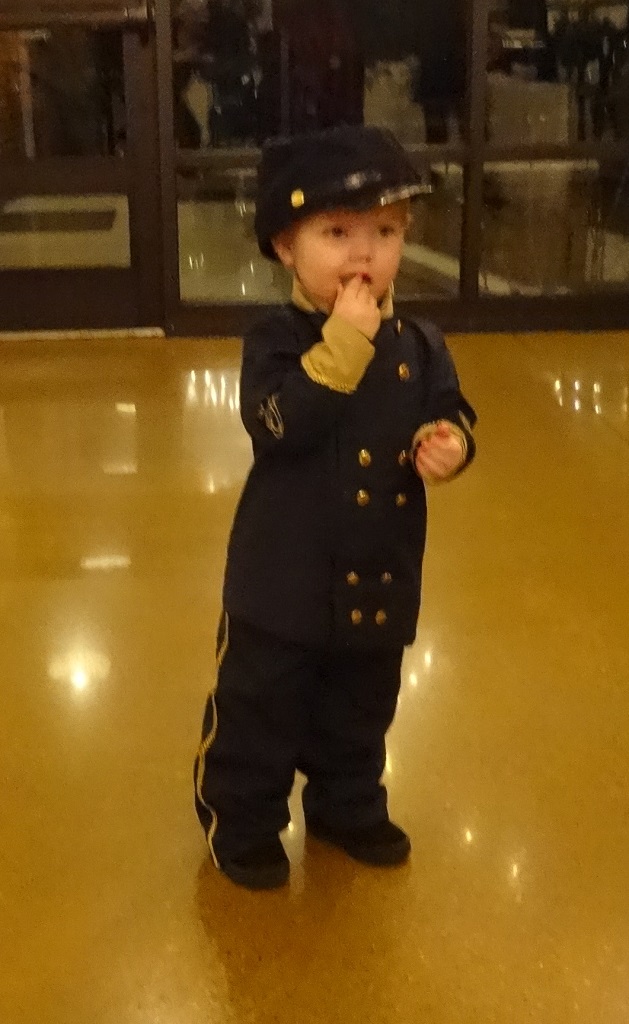 Toddler in uniform, eating